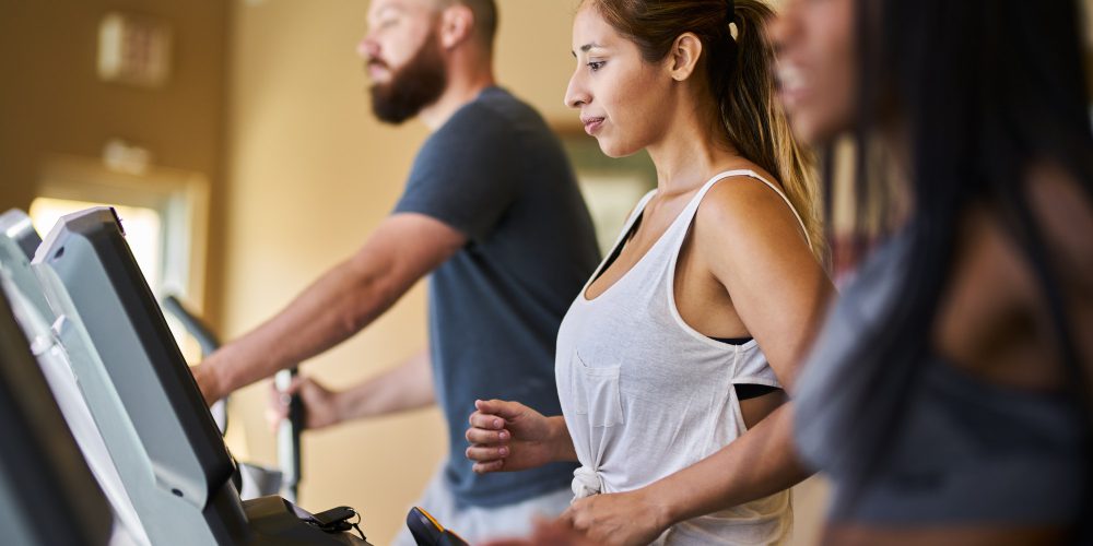 three-people-using-treadmills-in-gym-together.jpg